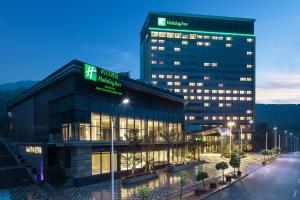 a building with a sign on the side of it at Holiday Inn Shaoguan Downtown, an IHG Hotel in Shaoguan