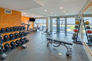 a gym with several treadmills and exercise machines at La Quinta by Wyndham Perry in Perry