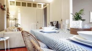 a dining room with a table with plates and glasses at ten2twelve in Espinho