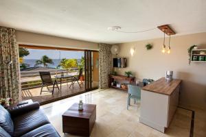 a kitchen and living room with a view of the ocean at Seaside Apartment Trupial in Kralendijk