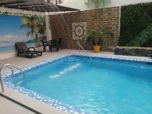 Bazén v ubytování Hostal Perla Real Inn nebo v jeho okolí