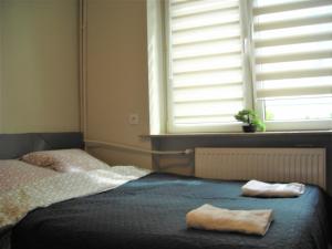 Łóżko lub łóżka w pokoju w obiekcie APARTAMENTY CENTRUM PAŁACOWA