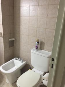 a bathroom with a white toilet and a sink at Acogedor monoambiente , en el centro de mendoza . in Mendoza