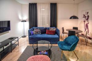 a living room with a blue couch and a table at Momo 123 Apartments in Belgrade