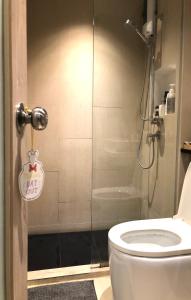 a bathroom with a shower and a white toilet at Bonne Nuit Hotel, Hua Hin in Hua Hin