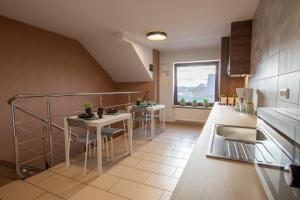 a kitchen with a table and some chairs in it at Villa Sol in Grzybowo