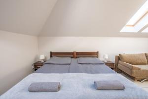 a bedroom with a large bed with two pillows on it at Villa Sol in Grzybowo