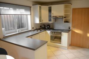 a kitchen with white cabinets and a counter top at Wohnung Ahorn in Riedstadt