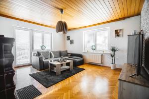 a living room with a couch and a table at Drive Caffe Apartments in Trzin