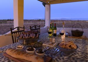 a table with bread and wine and wine glasses at Karoo Secret Secret House in Aberdeen +13 photos