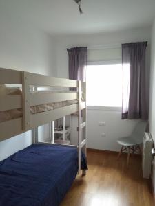 a bedroom with two bunk beds and a window at Apartamentos DEVA in Unquera +27 photos