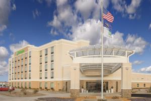 a building with an american flag in front of it at Holiday Inn - Terre Haute by IHG in Terre Haute