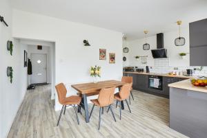 a kitchen and dining room with a wooden table and chairs at The Nook in Huddersfield