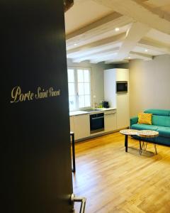 a living room with a couch and a table at Vannes Lodge in Vannes