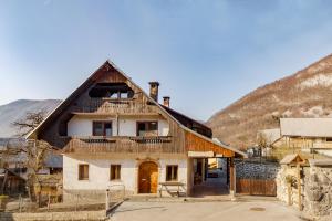 an old house with a thatched roof at Apartments Katja in Bohinj