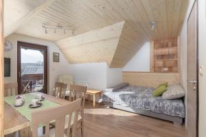 a bedroom with a bed and a dining table at Apartments Katja in Bohinj