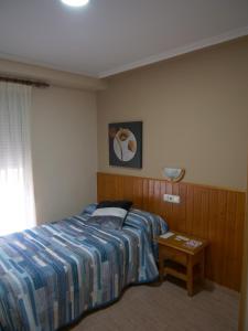 1 dormitorio con 1 cama y 1 mesa en Hostal Durá en Torrellano