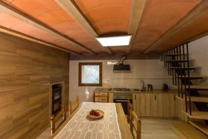 a kitchen with a table and a staircase in a house at Casa Rural La Vinyeta in Ballestar +22 photos