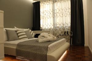 a bedroom with a bed and a couch in front of a window at Moro 34 in Bari