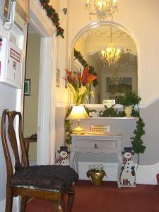 a room with a table and a mirror and a chair at Citadel House Hotel in Plymouth