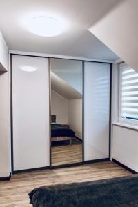a room with sliding glass doors with a bedroom in the background at Kaunas Castle Apartments - 2 Bedroom Flat in Kaunas