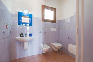 a bathroom with a sink and a toilet at Holiday home in Cala Gonone 34367 in Cala Gonone