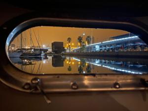 a rear view mirror of a boat in a marina at night at Confortable Yatch in Barcelona