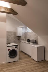 a kitchen with a washing machine and a stove at Kaunas Castle Apartments - Studio in Kaunas