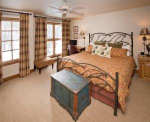 a bedroom with a large bed and a room with a table at Beaver Creek Village by Vail Resorts in Avon