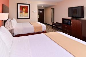 a hotel room with two beds and a flat screen tv at Holiday Inn New London, an IHG Hotel in New London