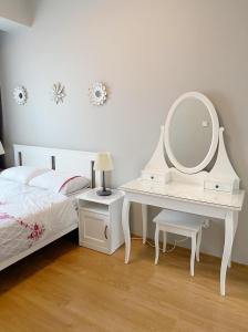 a bedroom with a bed and a dressing table with a mirror at Koza Apartment, next to Akbati Shopping Mall and Tennis court Soul Entertainment in Istanbul
