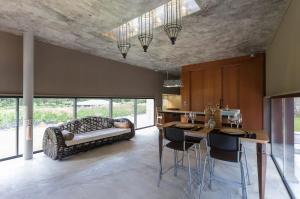 a kitchen with a table and chairs and a couch at Villa Astrolabio Refugio in Boa Vista