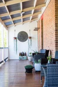 a patio with furniture and a brick wall at The Parkview Hotel Mudgee in Mudgee