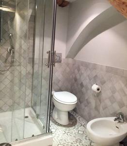 a bathroom with a toilet and a shower and a sink at Chiossone Suites in Genoa