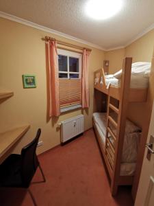 a bedroom with two bunk beds and a window at Apartmenthaus Atlantik in Kühlungsborn