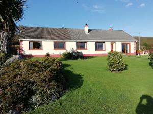 a house with a green lawn in front of it at Dunard house. in Tullaha