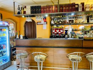 a bar with two stools in front of a counter at Penzión Tyché in Šurany