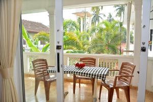 a dining room with a table and chairs on a porch at Yolanda Villa Negombo in Negombo