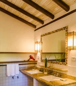 a bathroom with two sinks and a large mirror at Pousada Mundo Verde in Trancoso