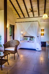 a bedroom with a large bed in a room at Pousada Mundo Verde in Trancoso