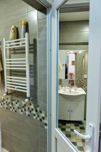 a bathroom with a sink and a mirror at Apartment on Rustaveli Avenue in Kutaisi