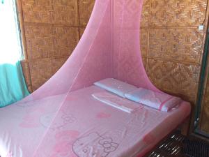 Postel nebo postele na pokoji v ubytování Junior & Nemesia's Cottages