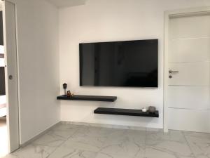 sala de estar con TV en la pared en Apartment Aria en Kobarid