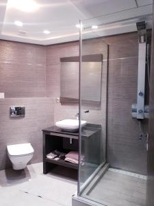 La salle de bains est pourvue d'un lavabo, de toilettes et d'une douche. dans l'établissement MAARIF LUXURY APART -Urban Massira IV-, à Casablanca