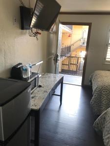 a kitchen with a counter top and a room with a bed at Westwind Lodge in Oakland