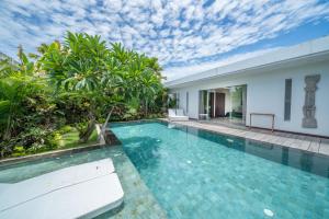 a swimming pool in the middle of a villa at Villa Bima - 3 Bedroom Villa in Seminyak in Seminyak