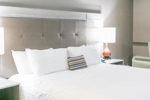 a bedroom with a white bed with two lamps at The Ridges Resort on Lake Chatuge in Young Harris