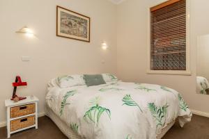 een slaapkamer met een bed en een raam bij 94Best Apartments in Wagga Wagga