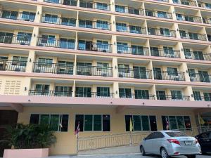 a car parked in front of a large building at A.A. Pattaya Golden Beach Hotel in Pattaya Central +24 photos
