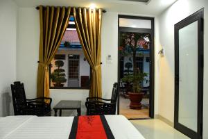 a bedroom with a bed and a sliding glass door at Asean Garden Homestay Hue in Hue